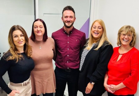 4 females and 1 male dressed smartly