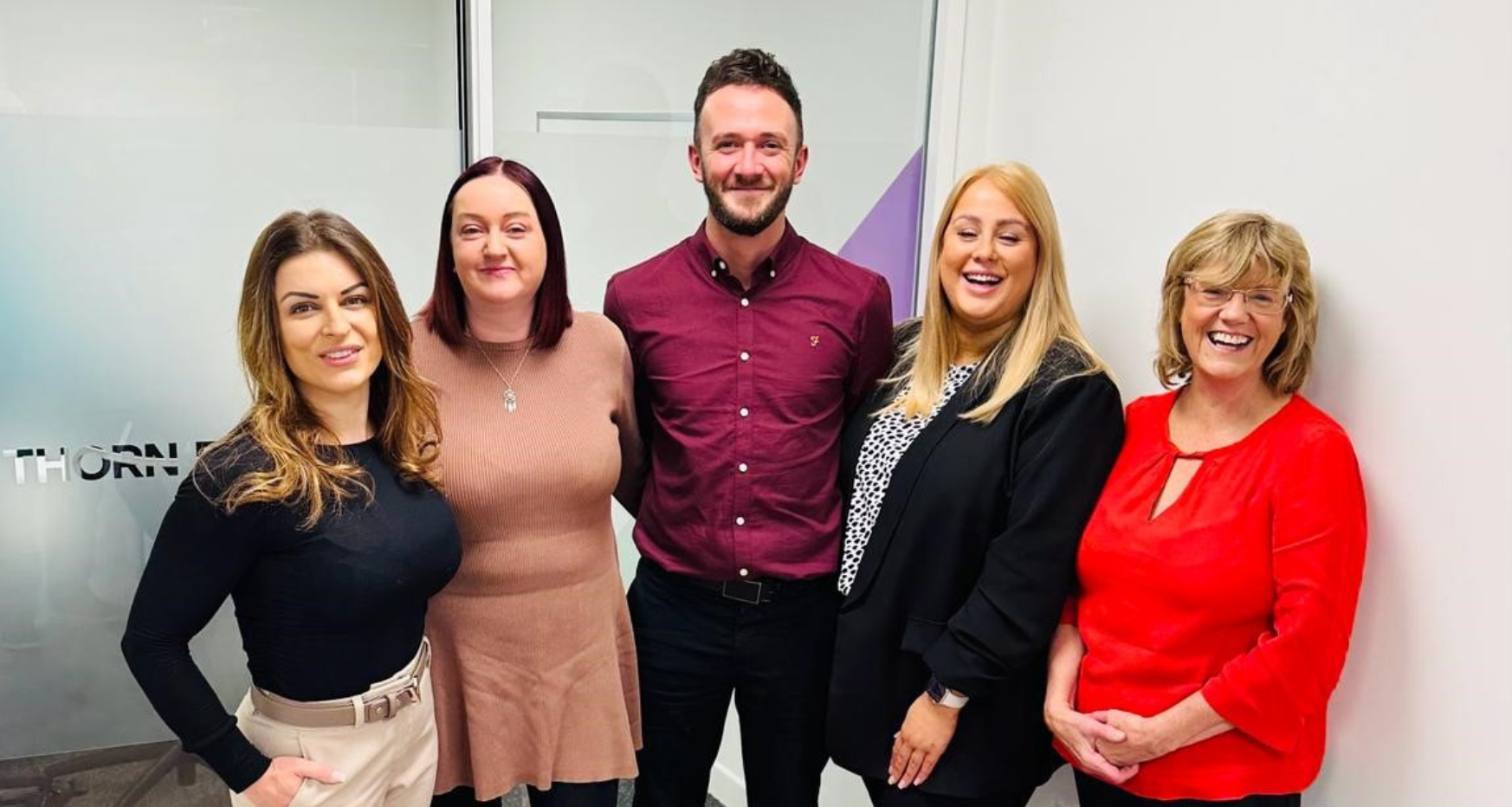 4 females and 1 male dressed smartly