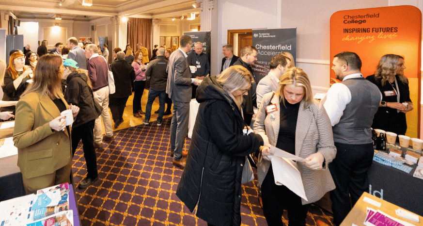 People networking in a room of exhibitors