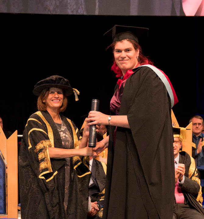 Elanore Ward receiving Inclusion Award at graduation, from Vice-Chancellor Professor Kathryn Mitchell