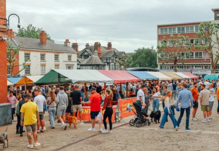 Crowds enjoying food at colourful market in Chesterfield