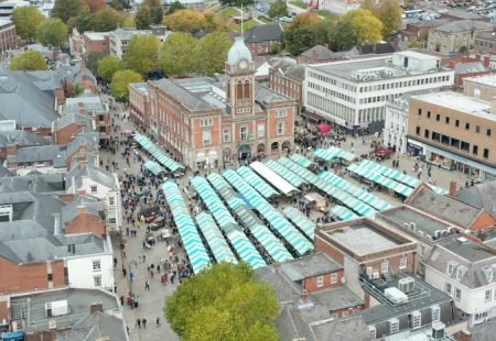 Birdseye view of Chesterfield market place with stalls and people