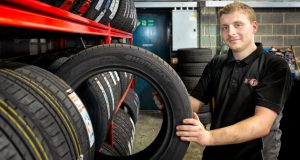Male employee at Eden Tyres choosing a tyre from the racking