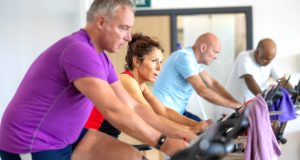 Two men and a woman on exercise bikes at Queen's Park Sports Centre