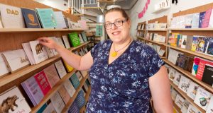 Female shop owner standing beside greeting cards at Shop Indie, Chesterfield town centre