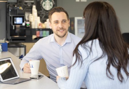 Man and woman having a coffee at work