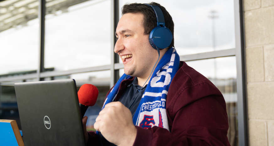 Josh Marsh in headphones behind mic at Chesterfield Football Club