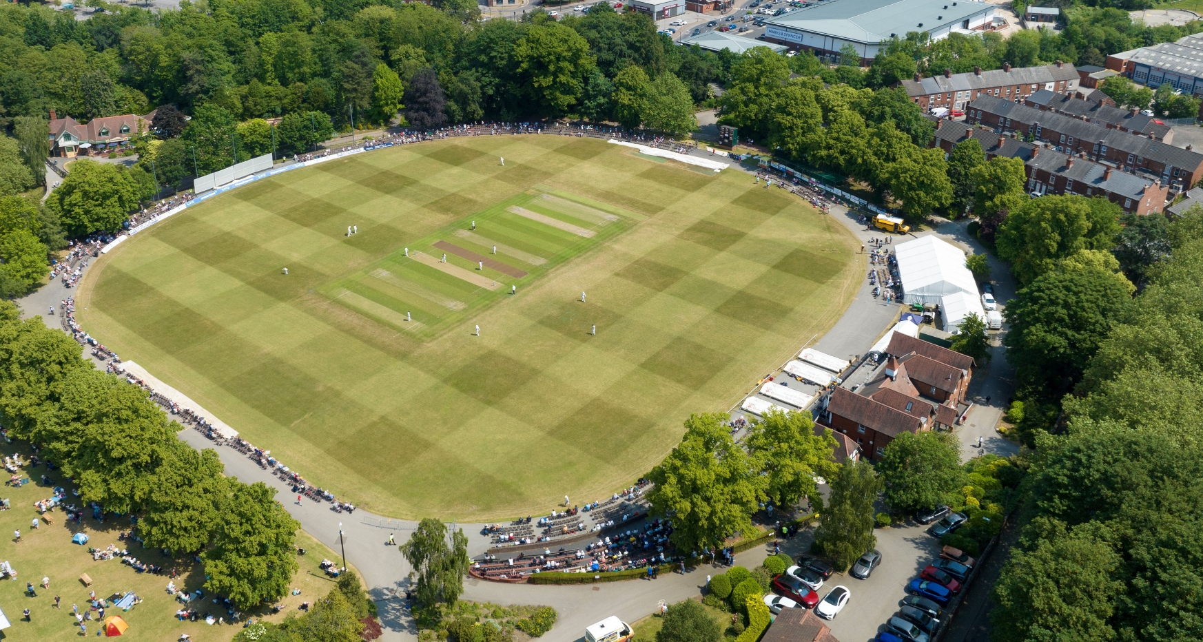Drone shot from above of the cricket pitch at Queens Park