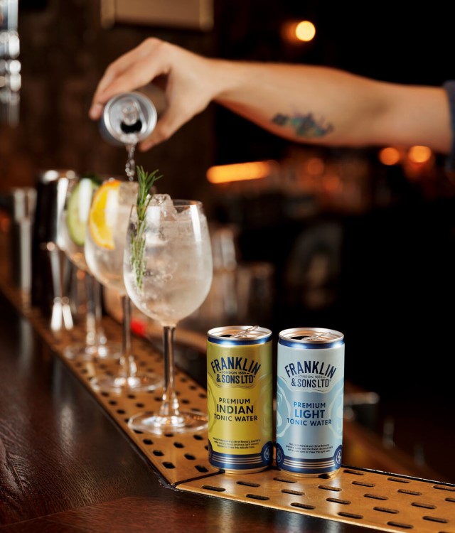 franklin and sons tonics cans on bar with man pouring drinks into glasses
