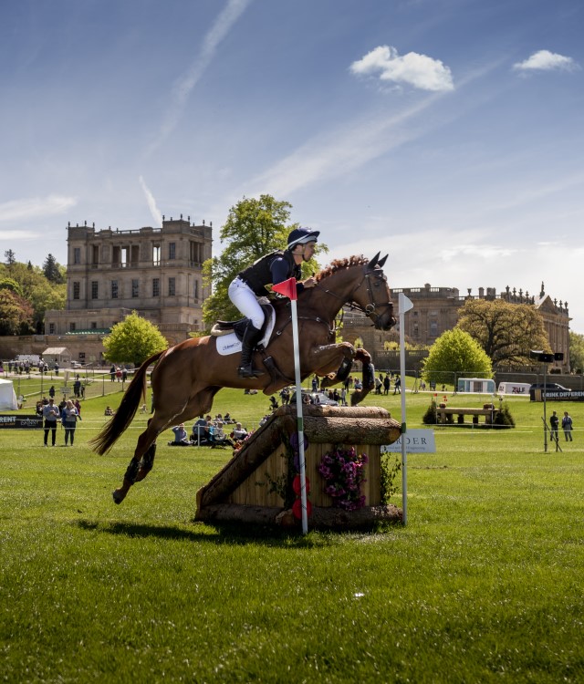 Chatsworth Horse Trials horse jumping over obstacle with house in background