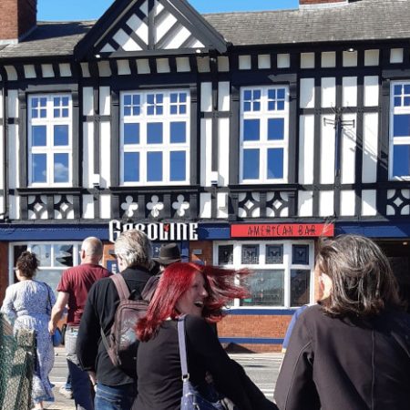 Group of people walking towards a tudor style pub