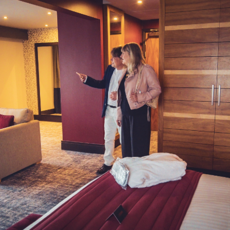 A couple explore their hotel room.
