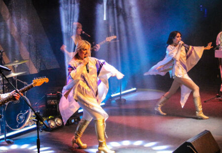 ABBA tribute band on stage performing.