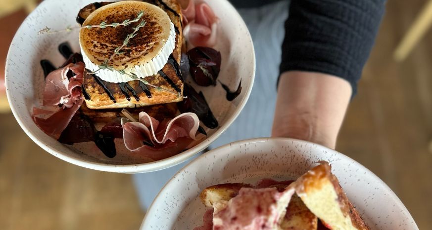 Brunch dishes in hand at Ninetyfour