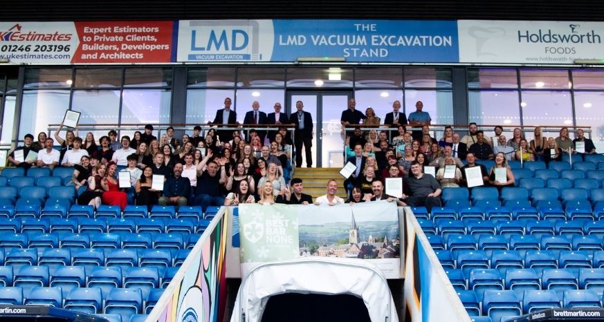 Group of people sat in stand at Chesterfield Football Stadium celebrating the Chesterfield 2025 Best Bar None awards