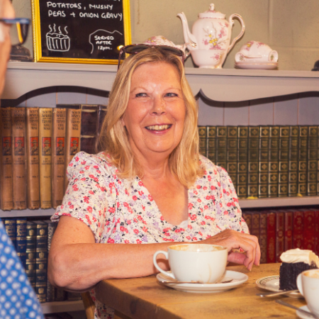 A couple having coffee and cake in a cafe.