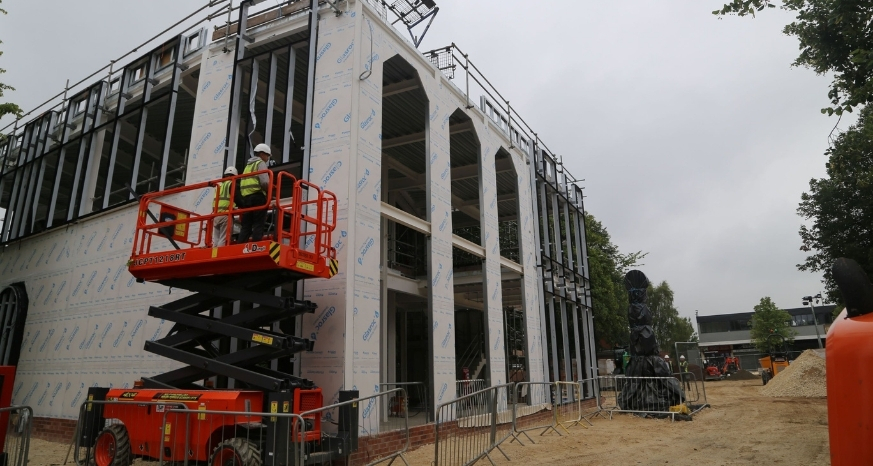 Workman building new building in Staveley Town Centre