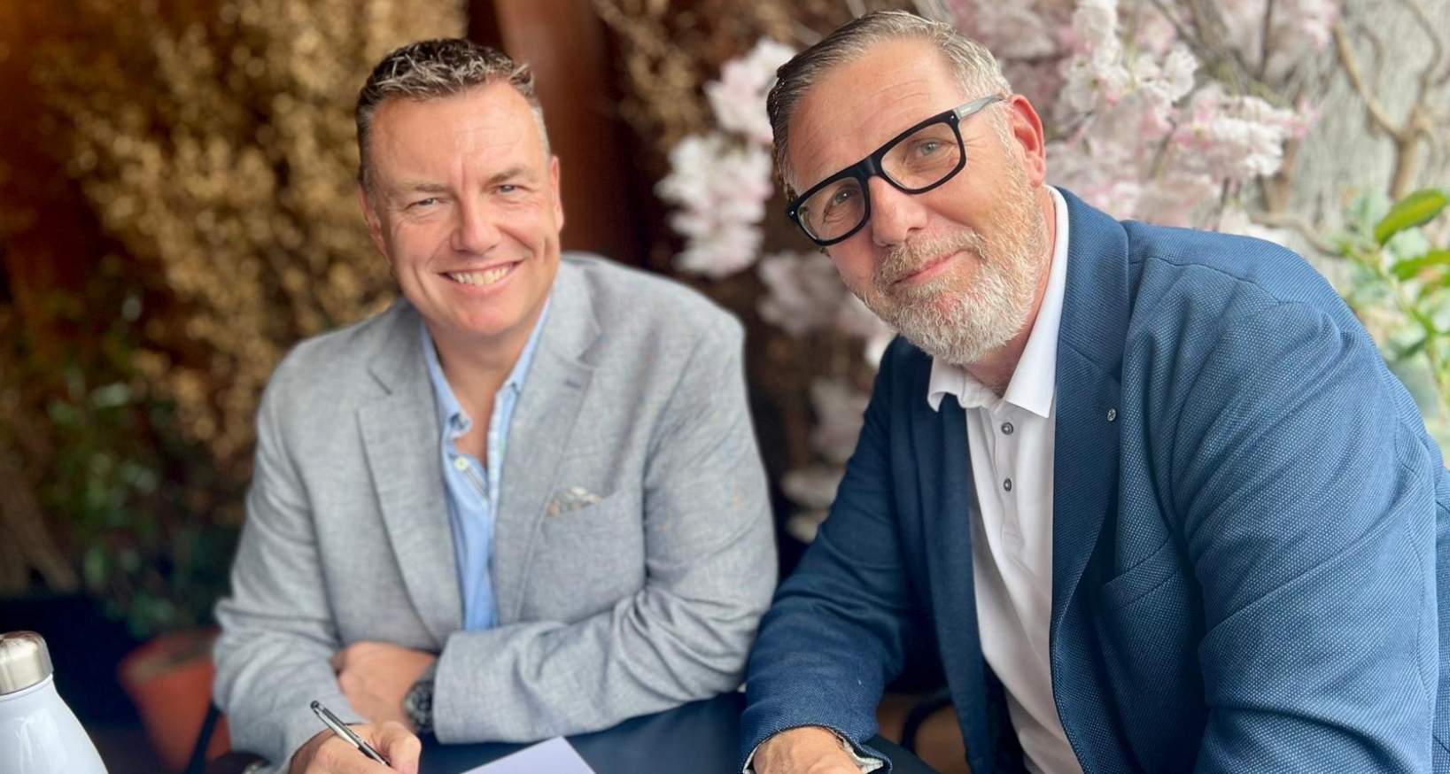 two men signing contract for coffee machine deal