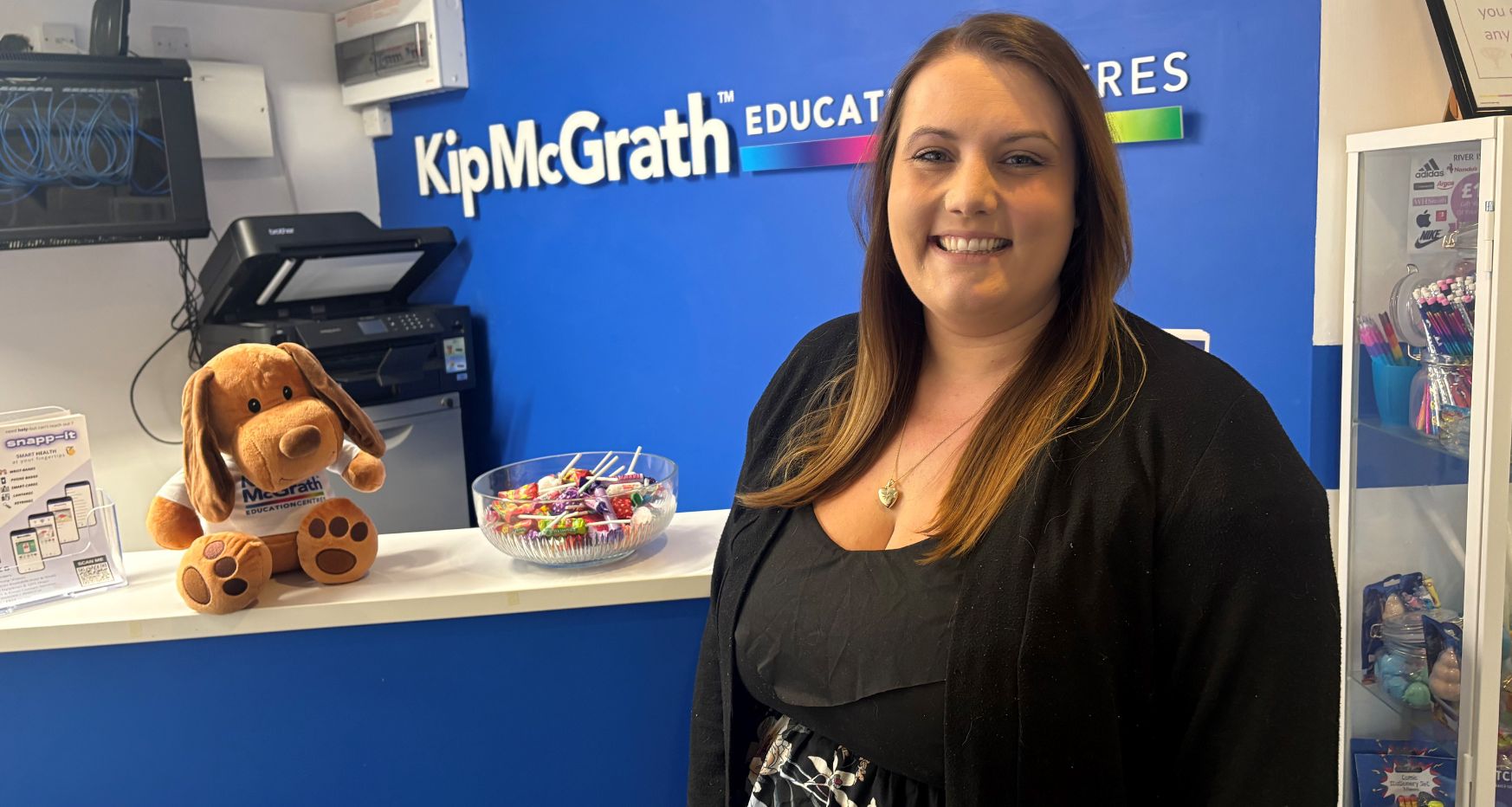 Lorna Bell owner of Kip McGrath stood in front of reception desk.