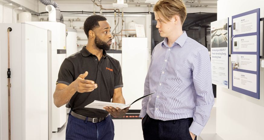 Two staff members discussing business support