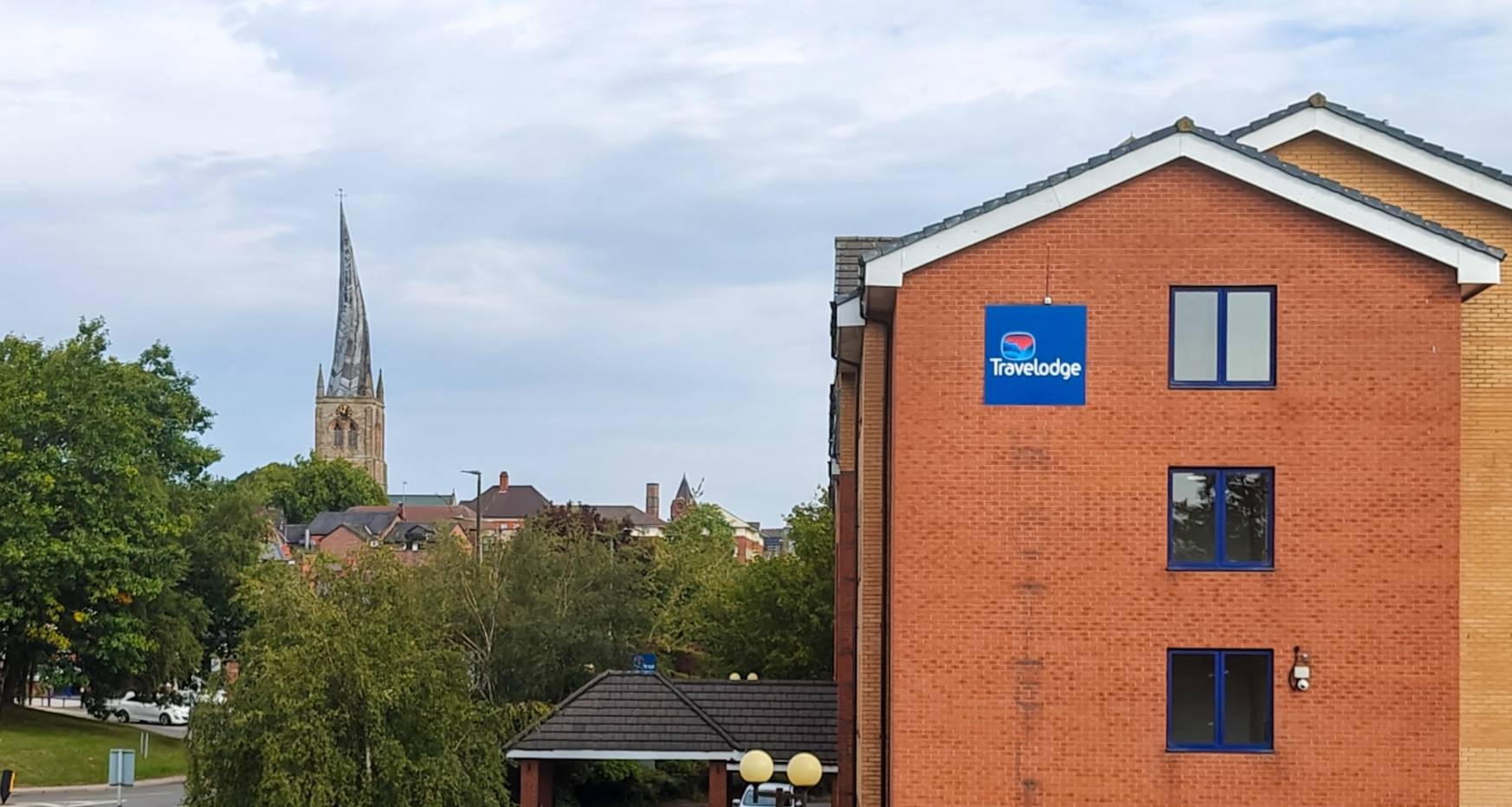 Image of Travelodge Chesterfield Town Centre with Crooked Spire in the background.