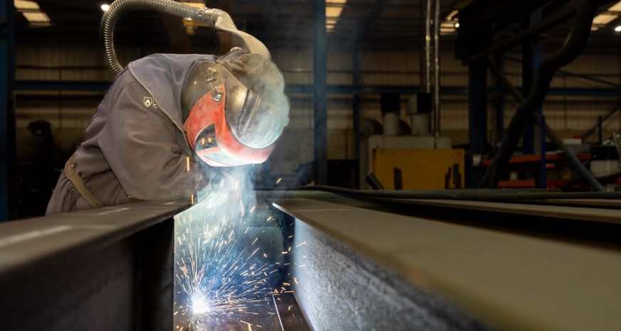 Person welding PPE and sparks