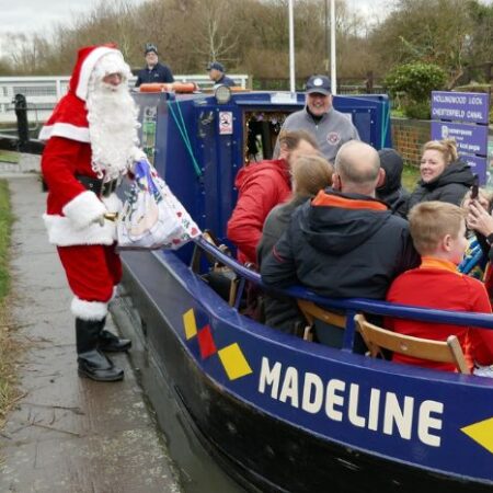 Santa greeting riders on the Santa Canal Cruise