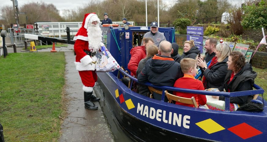 Santa greeting riders on the Santa Canal Cruise