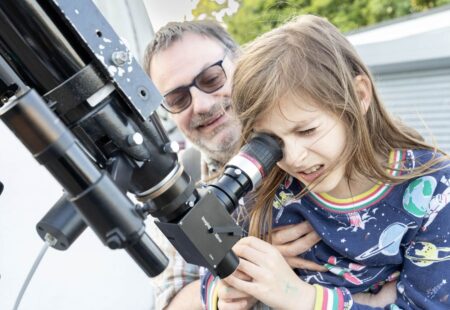 Man and young girl looking through telescope at Chesterfield Observatory