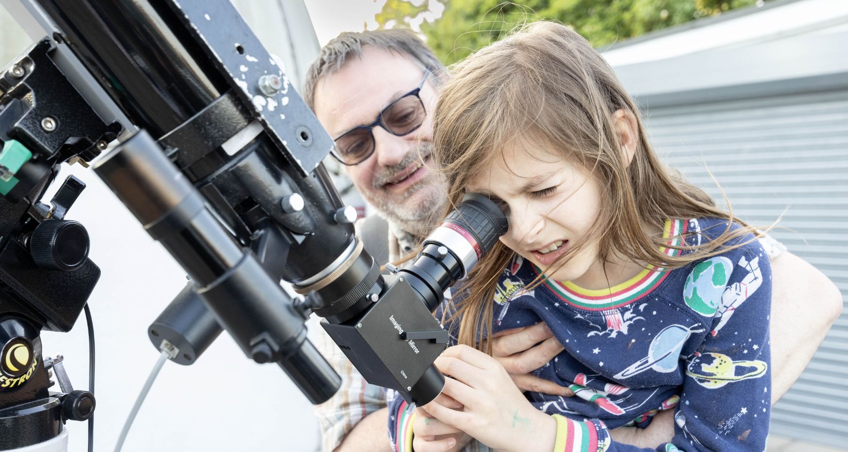 Man and young girl looking through telescope at Chesterfield Observatory