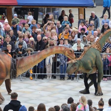 Audience watching dinosaur event in Chesterfield Market Place