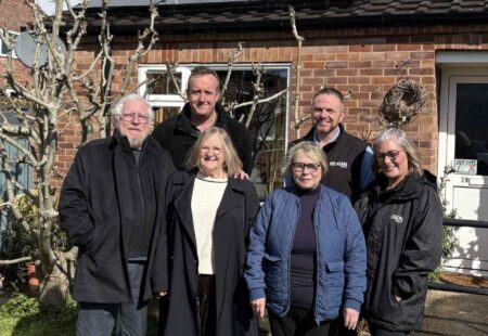 Pictures of a group of people stood outside a house in Chesterfield which will benefit as part of £4 million to help improve the energy efficiency of homes across Chesterfield.