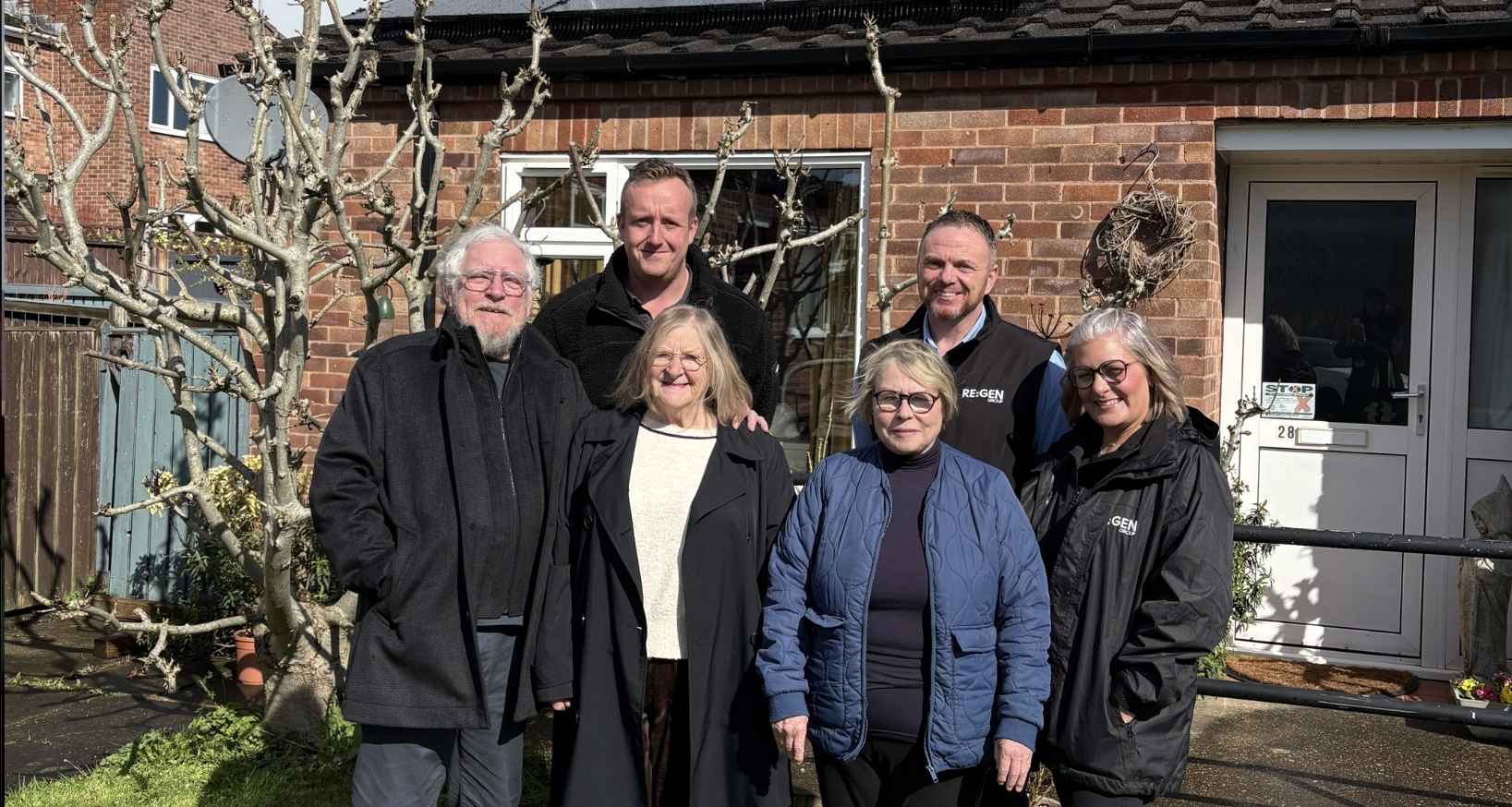 Pictures of a group of people stood outside a house in Chesterfield which will benefit as part of £4 million to help improve the energy efficiency of homes across Chesterfield.