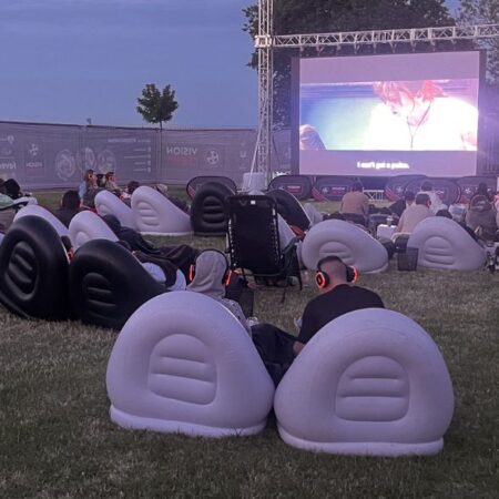 Event attendees watching a film outdoors on a big screen, promoting Chesterfield Outdoor Cinema coming to town