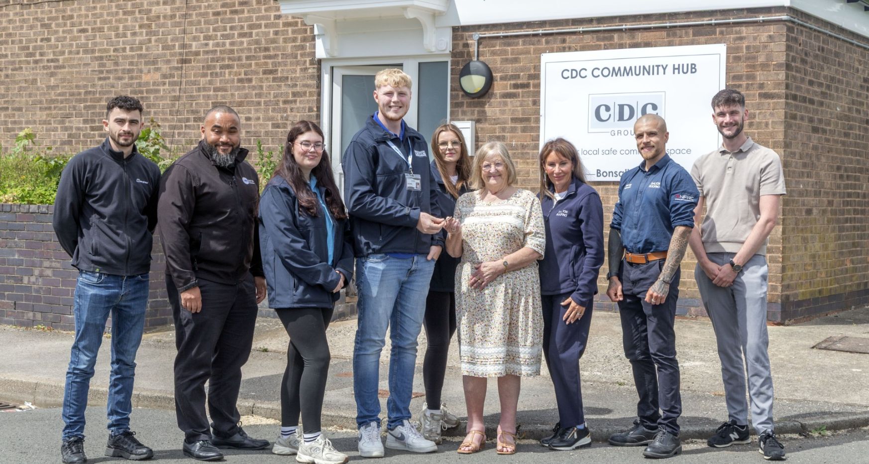 Apprentices standing outside Bonsall Court Community Development Chesterfield
