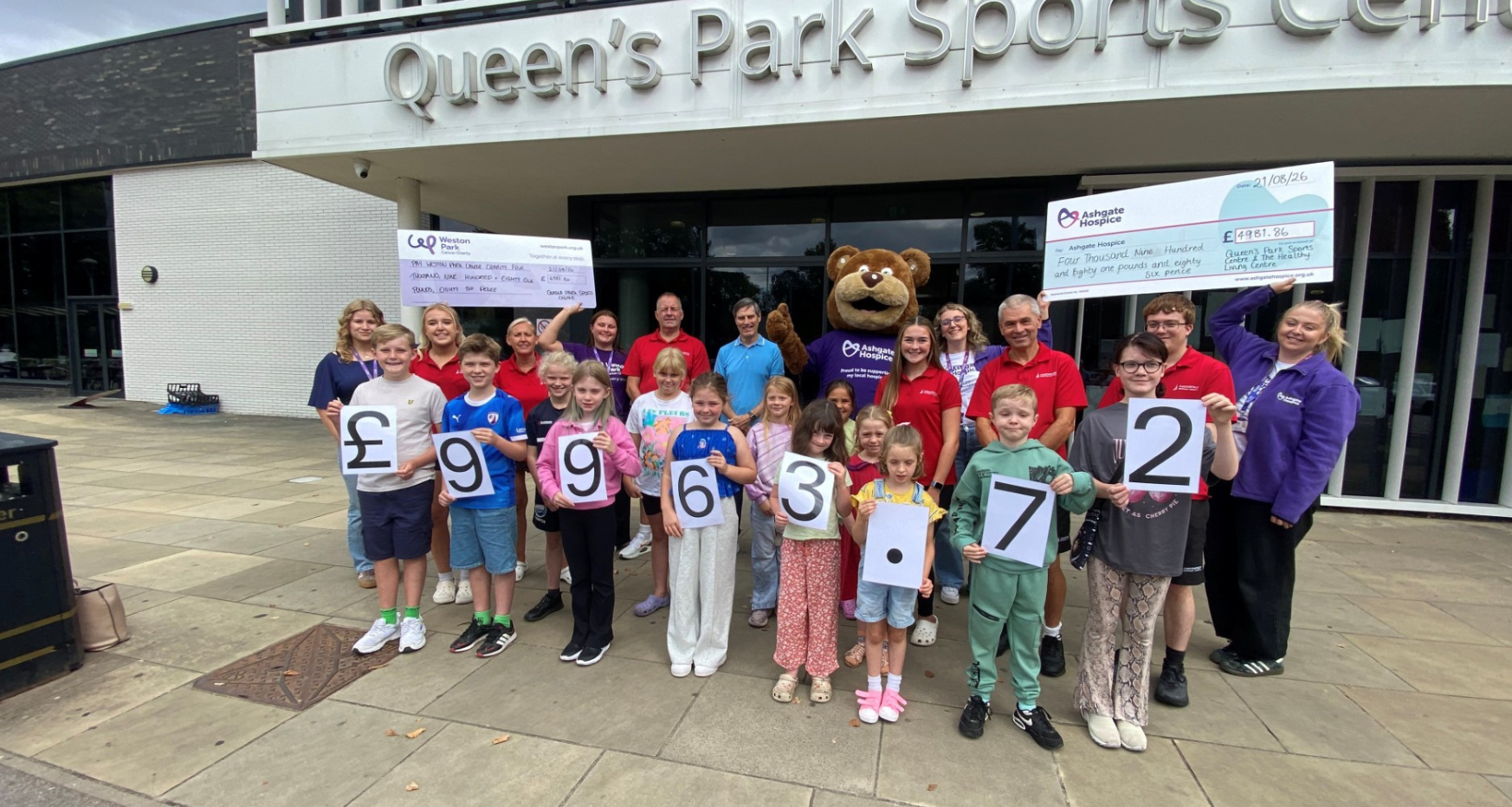 Councillor Gavin Baldauf-Good, Chesterfield Borough Council’s cabinet member for customers and business transformation, with representatives from both charities and some of the children who took part in the sponsored swim.